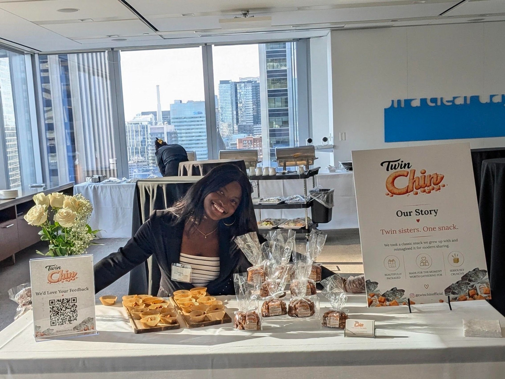Founder smiling at a pop-up table