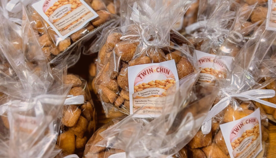 A close-up of TwinChin bags, crunchy chin chin pieces clearly visible through the packaging