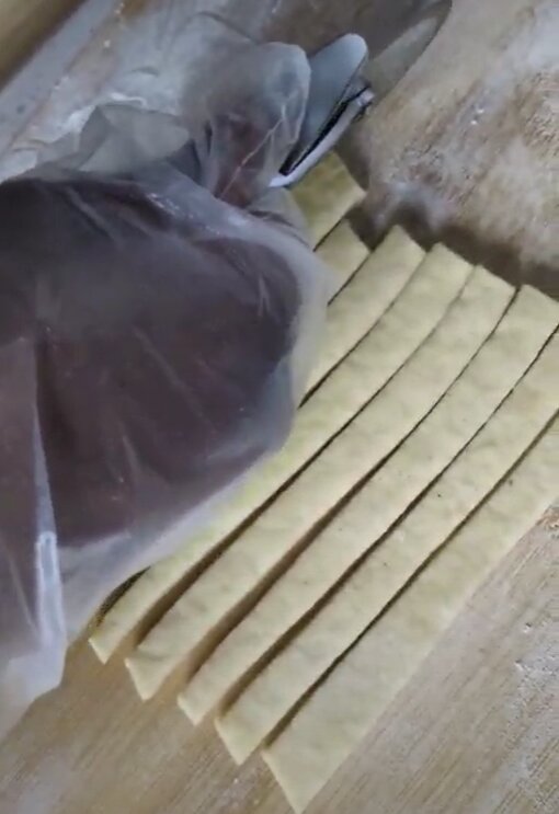 Chin chin dough cut into strips by hand
